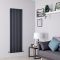 Milano Alpha Anthracite Vertical Designer Radiator 1780mm x 560mm in a grey sitting room with modern sofa SKU TDRASP25