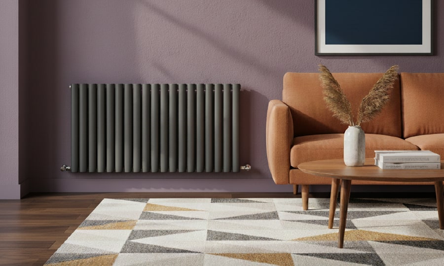 A tall orange radiator in a modern green sitting room surrounded by pictures