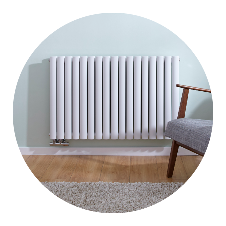 White Milano Aruba Flow designer radiator on a light green wall 